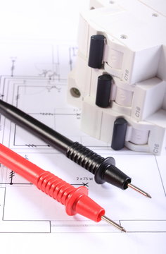 Cables of multimeter and electric fuse on construction drawing