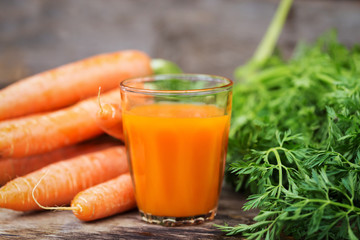 Carrot juice on wooden background