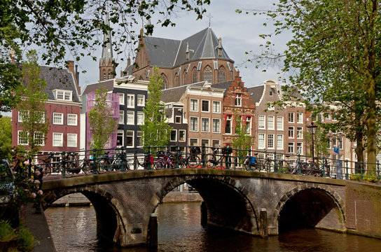 Amsterdam canals with bridge and typical dutch houses