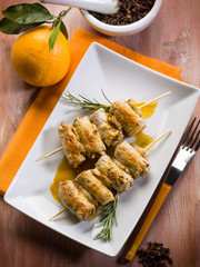 skewer rolled up with clove and orange juice