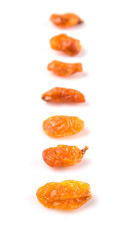 Dried orange colored raisin over white background