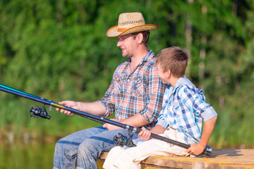 boy and his father fishing togethe