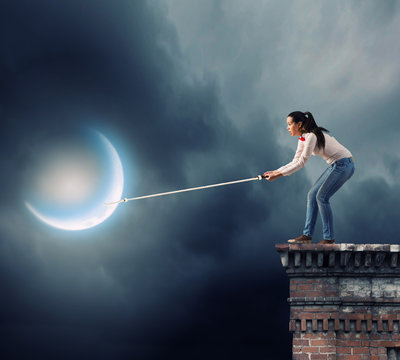 Woman catching moon