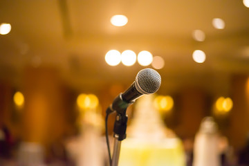 microphone in concert hall or conference room with warm lights i
