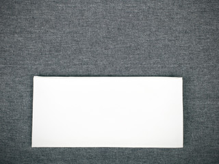 white napkin on a gray tablecloth