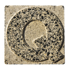 Letter Q carved in a concrete block
