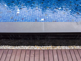 Naklejka premium Swimming pool with wooden and stone