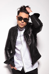 man looking at the camera while fixing his hair.