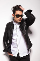 Fashion young man fixing his hair