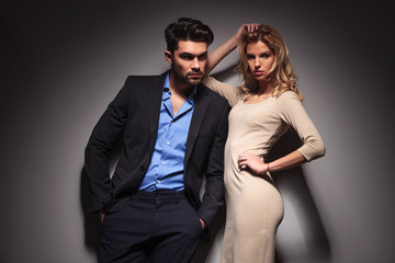 business man looking away while his lover fixing her hair.