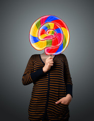 Fototapeta premium Young woman holding a lollipop