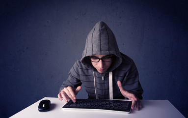 Hacker working with keyboard on blue background