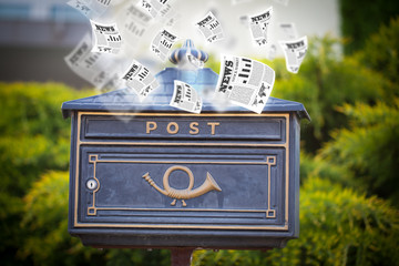 Post box with daily newspapers flying