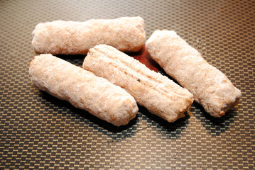 Closeup of Frozen Sausage Links in a Fry Pan