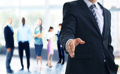 A business man with an open hand ready to seal a deal