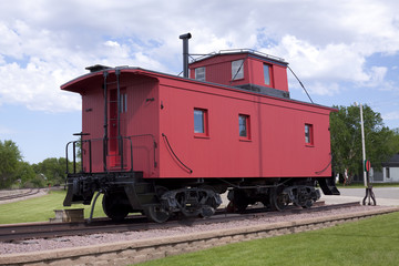 Fototapeta na wymiar Red Railroad Caboose On Train Track