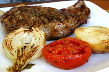 close-up meat steak on the plate with vegetables