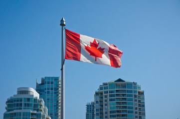 Canadian flag on the Vancouver skyscrapers background