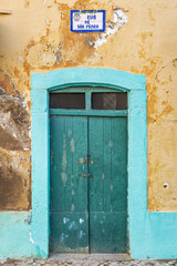 Fototapeta na wymiar Typical green doorway in the old town of Olhao