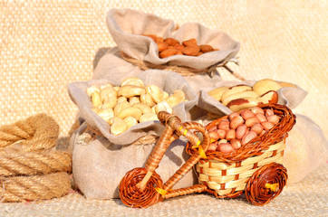 cashew nut, peanut, brazil nut in the bags on the sacking fabric