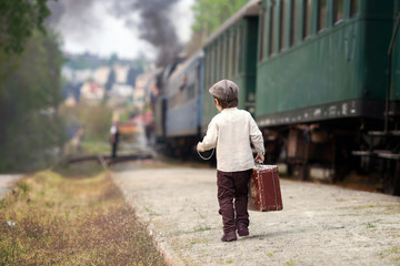 Boy, dressed in vintage shirt and hat, with suitcase