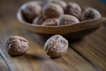 wooden bowl with walnuts on table