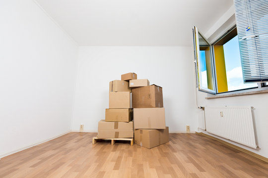 cardboard boxes in an empty apartment. moving to a new apartment