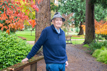 Active Senior Man in Autumn Arboretum and Garden