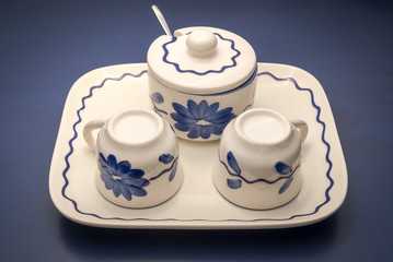 Coffee set with two cups, plate and sugar pot with spoon
