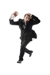 stressed businessman with take away coffee running late to work