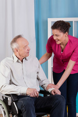 Disabled man on wheelchair and nurse