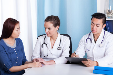 Doctor comforting mongolian woman