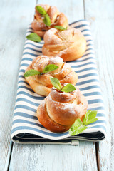 Tasty buns with berries on table close-up