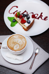 Cup of coffee with cute drawing in cafe