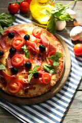 Delicious pizza served on wooden table