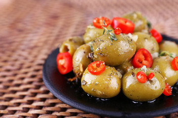 Green olives in oil with spices and rosemary