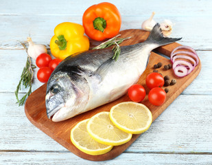 Fresh raw fish and food ingredients on table