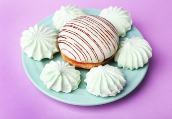 Mint color meringues and tasty cake on color background