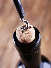 Bottle opener close-up, on wooden background