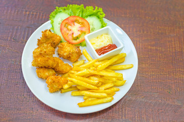 Traditional French potato fries with tomato salad ketchup and ma