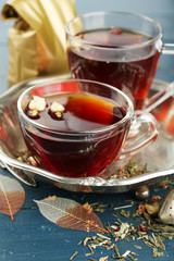 Beautiful vintage composition with herbal tea, on wooden table