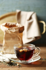 Beautiful vintage composition with herbal tea, on wooden table