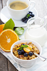 Breakfast set on the table with granola