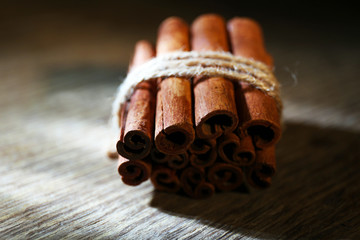 Cinnamon on dark wooden background, close-up