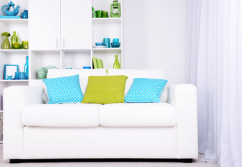 Modern interior design. White living room with sofa and