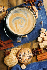 Cup of coffee and chocolate chip cookies on wooden background