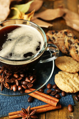 Cup of coffee and chocolate chip cookies on wooden background