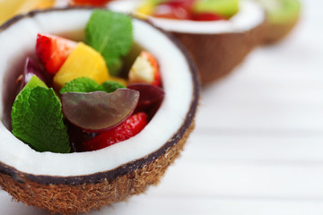 Fruit salad in coconut on table