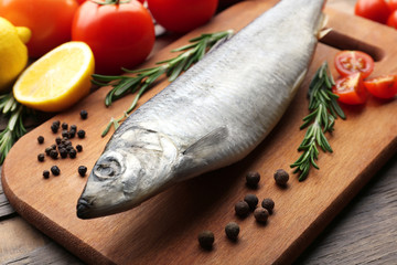 Fresh raw fish and food ingredients on table
