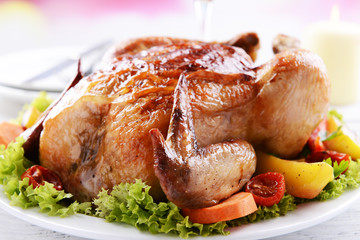 Delicious baked chicken on plate on table on light background